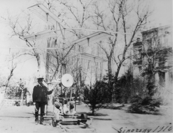 1910. AA. Kyiv, Ukraine. Igor Sikorsky with H-2 (second helicopter prototype) in the backyard of the Sikorsky Family house at 15Б Yaroslaviv Val Street, Kyiv, Ukraine.  A copy of the photograph is posted in the U.S. Embassy in Ukraine building at 4 Aviaconstructor Igor Sikorsky Street, Kyiv, Ukraine. Provided by the Sikorsky Family and Robert Homans.