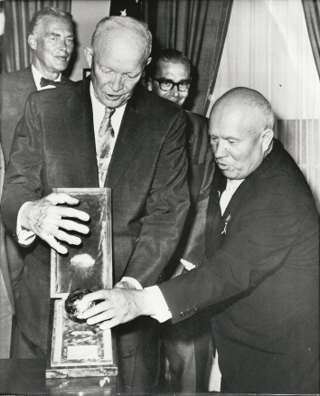 1959, September 15. EA. Washington, District of Columbia. MOON-ROCKET MODEL: President Eisenhower is examining a model of the sphere, which a Soviet moon rocket landed on the Moon. Soviet Premier Khrushchev gave him the model during a series of White House Talks. AP Wirephoto (Front)