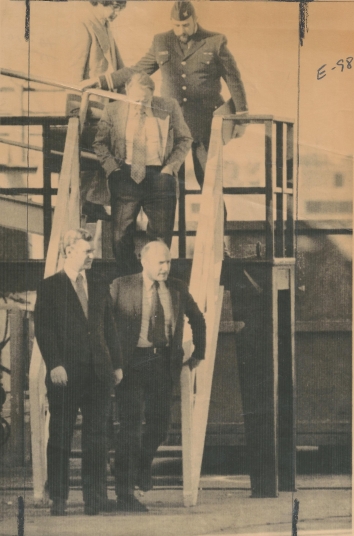 1977, April 15. BA. Boston, Massachusetts. ENROUTE ARRAIGNMENT. - Captain Aleksandr Gupalov is escorted from the Soviet fishing vessel Taras Shevchenko enroute to his arraignment in U.S. District Court in Boston. AP Wirephoto (Front)