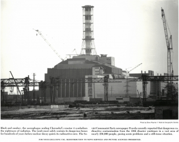 1986, December. DA. Chernobyl, Soviet Ukraine. Black and somber, the sarcophagus sealing Chernobyl's reactor 4 symbolizes the nightmare of radiation. the tomb must safely contain its dangerous bones for hundreds of years before nuclear decay quits its radioactive core. The Soviet Communist Party newspaper Pravda recently reported that dangerous radioactive contamination from the 1986 disaster continues in a vast area of nearly 250,000 people posing acute problems and a still-tense situation. National Geographic Society Photo by Steve Raymer