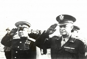 1945, August 11. EA. Moscow, Soviet Russia. "IKE" ARRIVES IN MOSCOW.  Marshal Gregory Zhukov and General of the Army Dwight O. Eisenhower (Right) salute as the American and Russian national anthems are played at Moscow airport. ACME Radiophoto (Front)