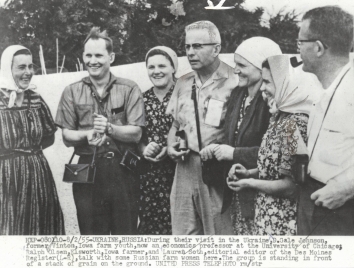 1955, August 2. DA. Soviet Ukraine. During their visit in Ukraine, D. Gale Johnson, former Viton Iowa farm youth, now an economics professor at the University of Chicago; Ralf Olsen, Elsworth Iowa farmer, and Lauren Soth, editorial editor of the Des Moines Register (L-R), talk with some Russian farm women here. United Press Telephoto (Front)