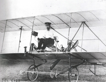 1910. AB. Kyiv, Ukraine. Igor Sikorsky seated at the forward edge of his first airplane desing, S-1. (Credit: National Air and Space Museum)