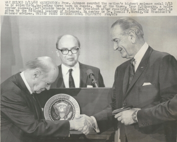 1968, February 13. AA. Washington, District of Columbia. President Lyndon B. Johnson awarded the nation's highest science medal 2/13 to 12 scientists, including three born in Ukraine (Igor I. Sikorsky, George B. Kistiakowsky, Gregory Breit). One of the three, Igor I. Sikorsky, a helicopter pioneer, (left) shakes hands with the President after receiving his medal. The medal is given by the National Academy of Sciences. In center is Dr. Donald F. Hornig, the President's science adviser. United Press International Telephoto.