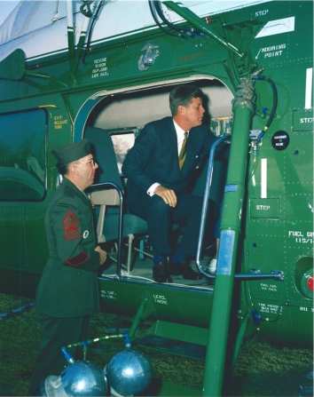 1961, February 10. AA. Washington, District of Columbia. President John F.  Kennedy inside Marine One, the Presidential helicopter VH-34, produced by Sikorsky Aircraft, settles his daughter Caroline Kennedy (out of frame). That day the First Lady Jacqueline Kennedy and daughter Caroline Kennedy were departing the White House for Glen Ora in Middleburg, Virginia. South Lawn, White House, Washington, D.C. Photo by Robert Knudsen