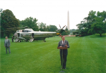 1992, August 17. AA. Washington, District of Columbia. President George H. W. Bush is speaking on the White House Lawn in front of the Marine One, a Sikorsky VH-3D Sea King helicopter. During a news conference, President Bush denies reports that suggest he would launch strikes against Iraq this week to boost his re-election bid. Bush is preparing to leave for Houston for the Republican conference (Front)